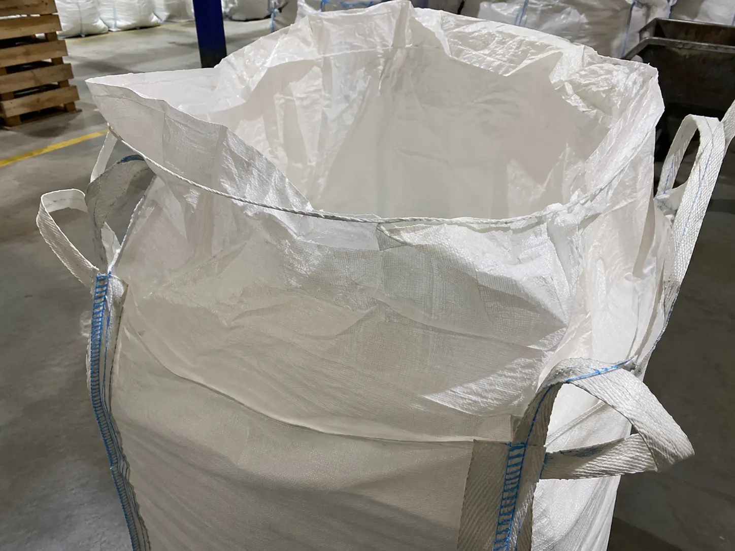 Close-up of a duffle top FIBC bulk bag showing the gathered fabric skirt used to tie the bag closed after filling