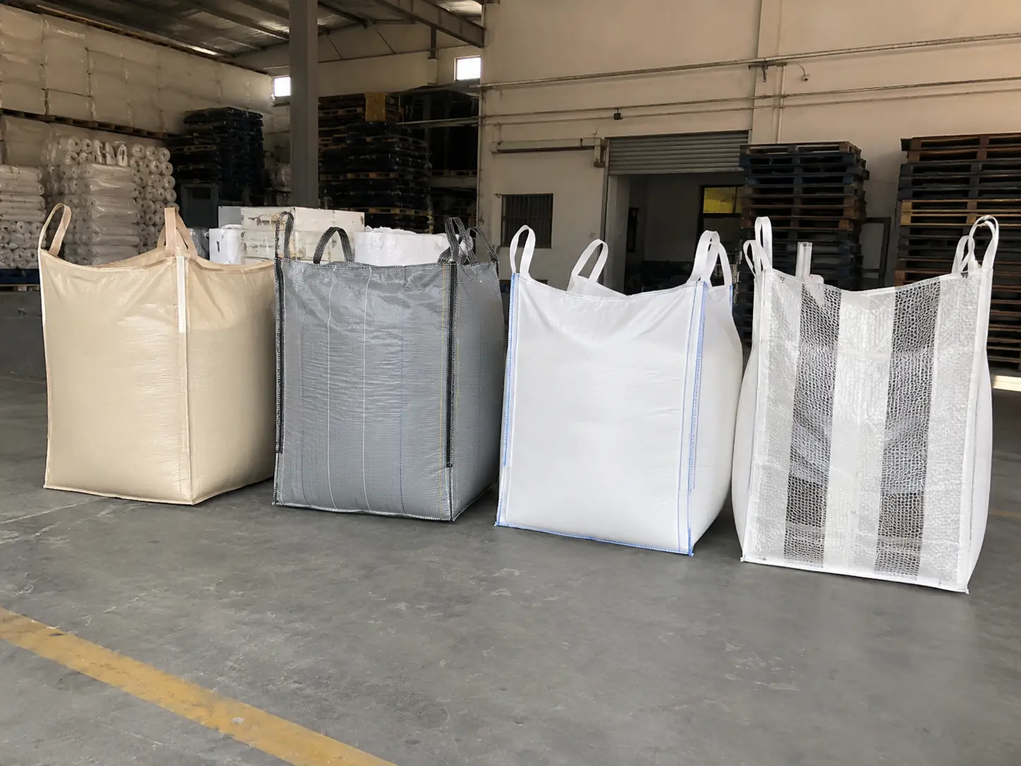 Different types of FIBC bulk bags lined up side by side — standard, anti-static, food grade, UN certified, baffle and ventilated