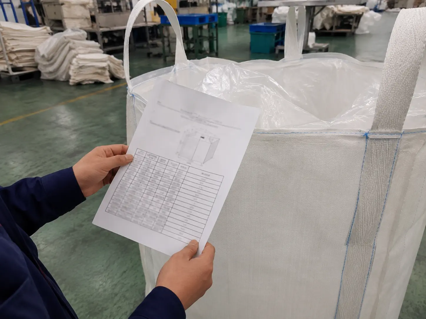 Reviewing an FIBC bulk bag specification sheet listing capacity, fabric weight, safety factor and certification details