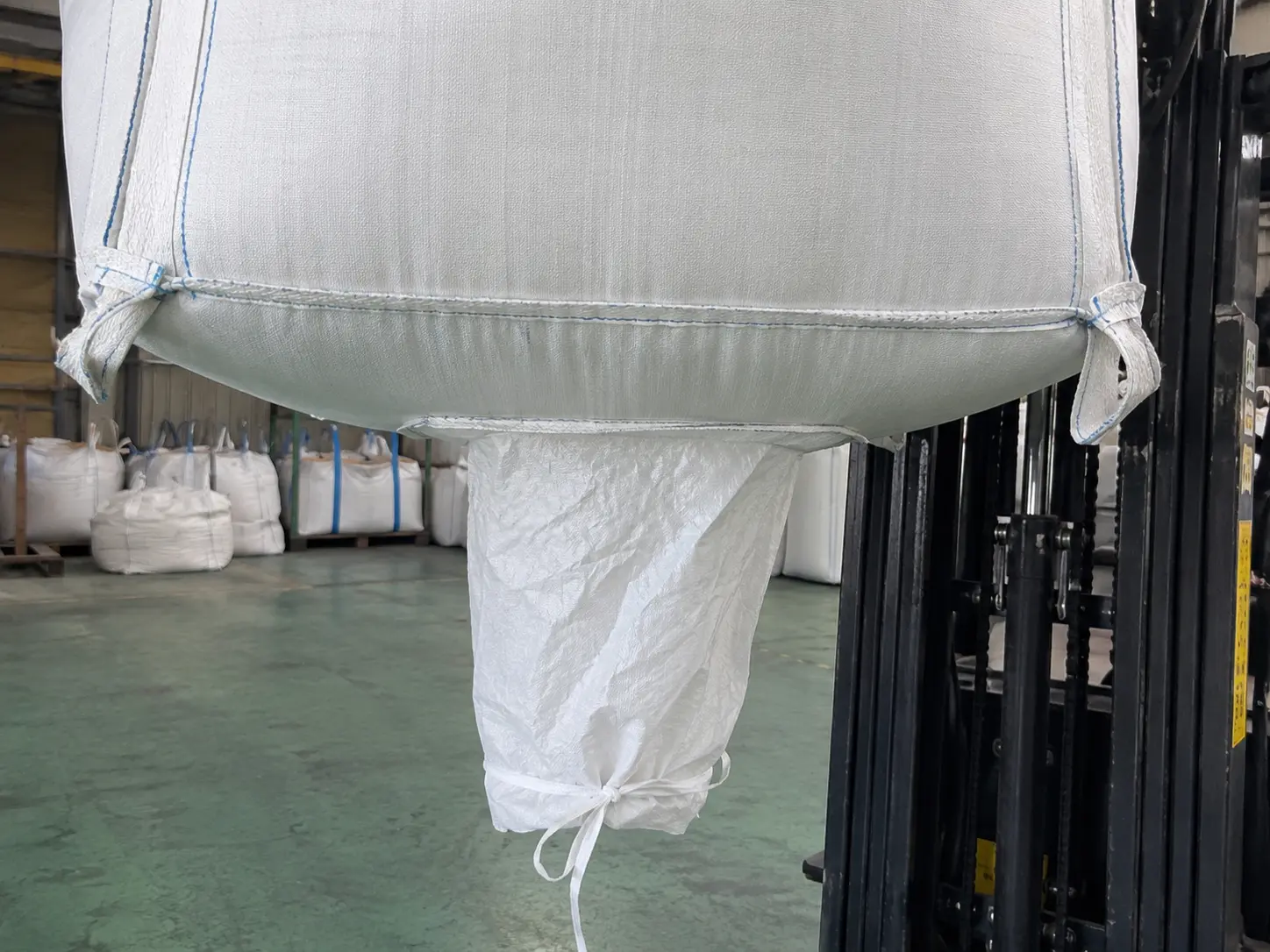 Close-up of a spout bottom FIBC discharge outlet for controlled product release